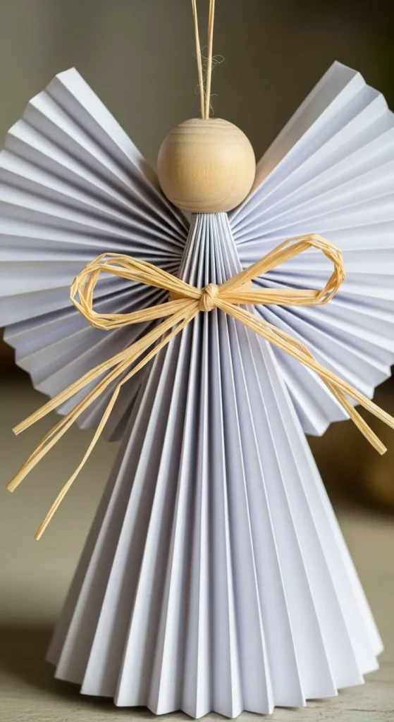 The classic DIY folded paper angel ornament with accordion pleats, a simple and charming christmas tree decorations diy craft.